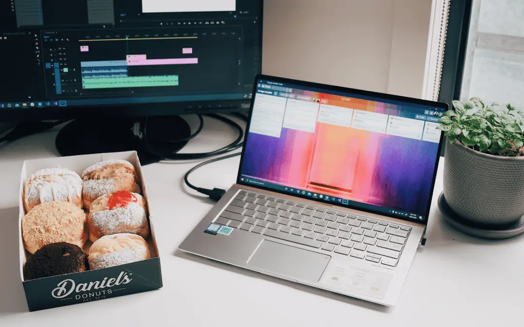 trello boards on laptop next to donuts and desktop organize with trello